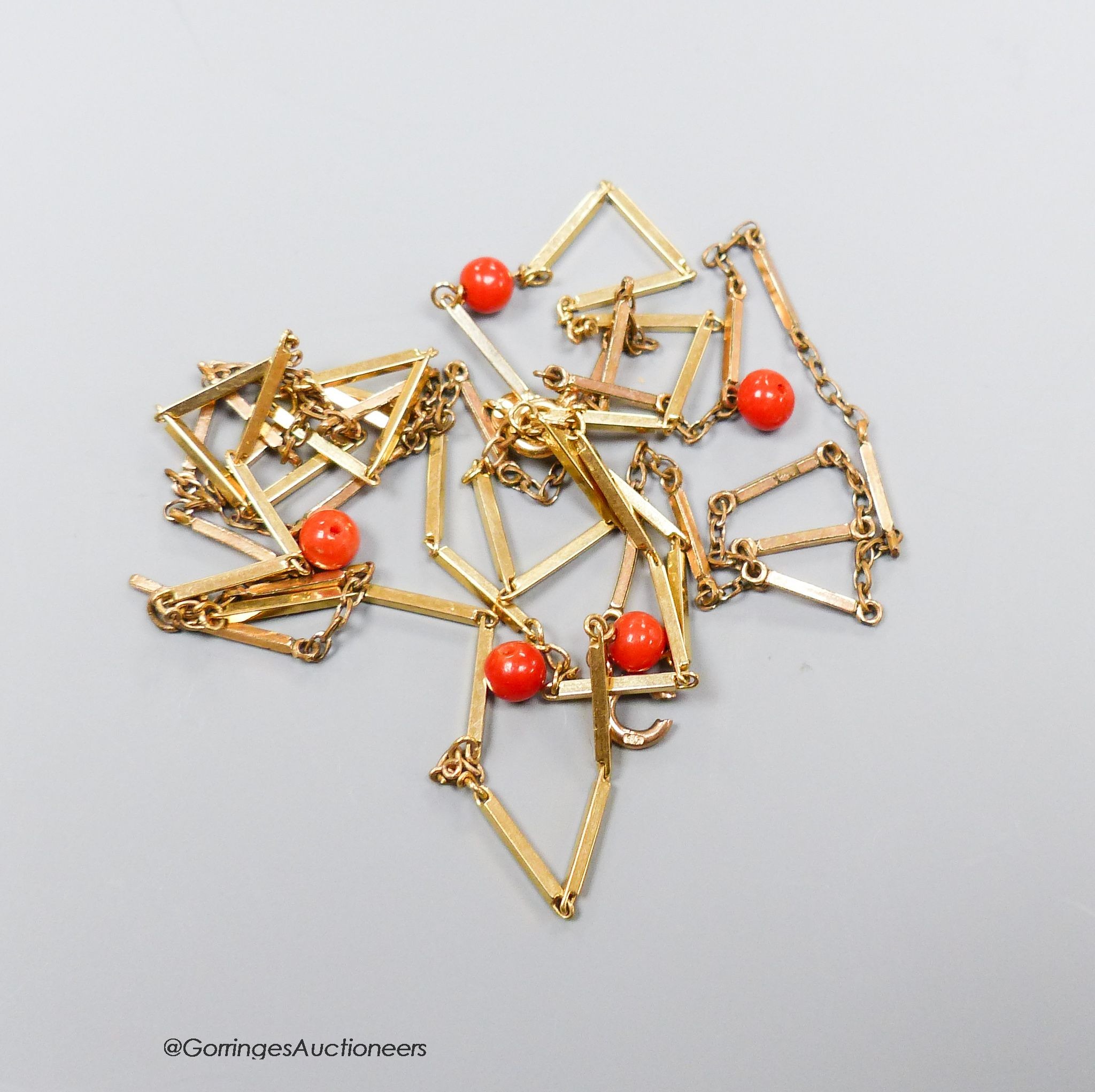 A 9ct. gold coral bead necklace, gross 9.6g, 86cm. (a.f).